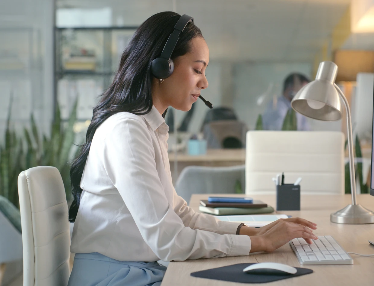 Woman working at desk with headset